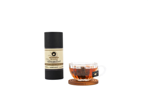 A tube and a cup of brewed tea showing earl grey biodegradable loose leaf tea bags