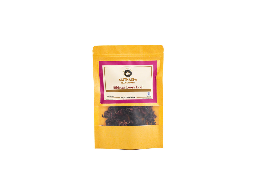 A packaged product of Muthaiga Healthy Hibiscus Tea in Kenya with a yellow label and a transparent window showing the brown hibiscus leaves inside.