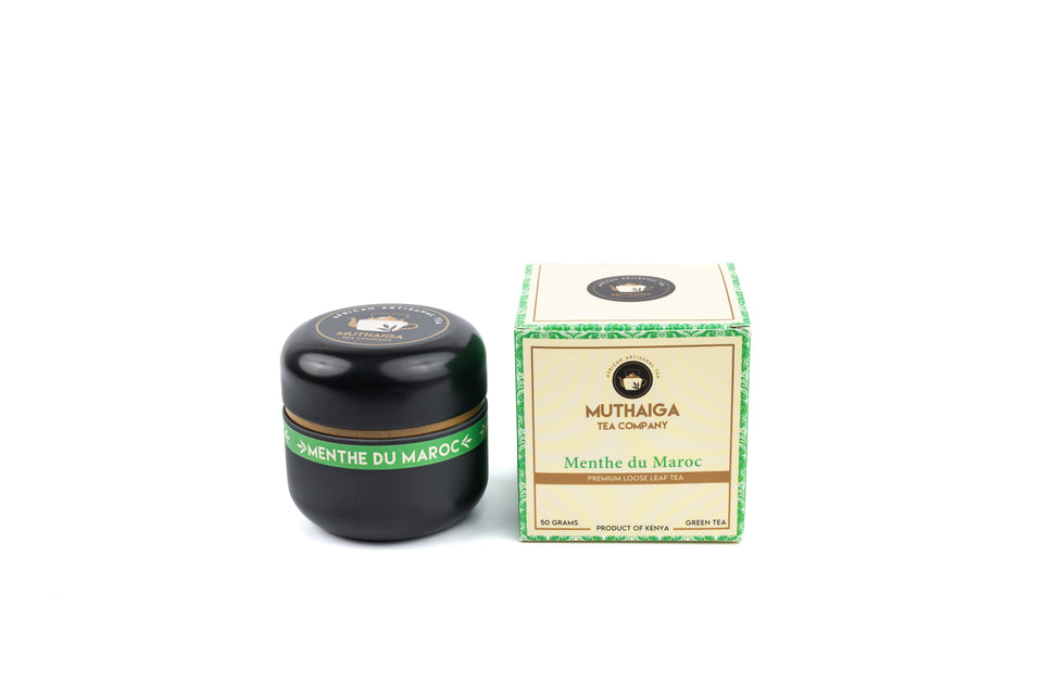A packaged box of Menthe du Maroc, Tastiest green tea in Kenya, next to a small container of the loose leaf tea leaves.