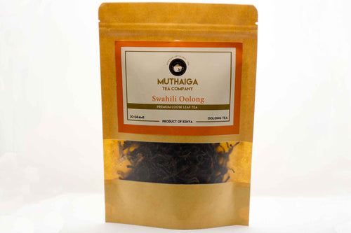 Packaged Swahili Oolong Oolong Tea Blend, a digestive tea in Kenya,  with visible leaves through the transparent section of the packaging, labeled as Muthaiga Tea Company.