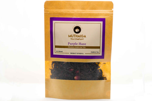 Packaged premium loose leaf purple tea in Kenya with visible tea leaves and rose petals in a clear pouch with a purple label, branded as 'MUTHAIGA Tea Company'.