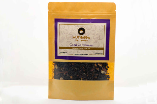 Packaged loose leaf tea visible through a clear window on a yellow background, with a purple label stating 'Coco Zambarau - Purple loose Leaf Tea Blend'.