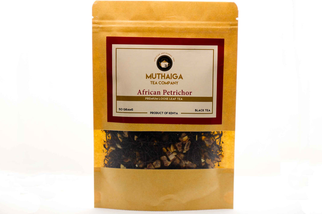 Packaged black tea in Kenya labeled 'African Petrichor' by Muthaiga Tea Company, with visible dried leaves and pieces of date and almond flakes.